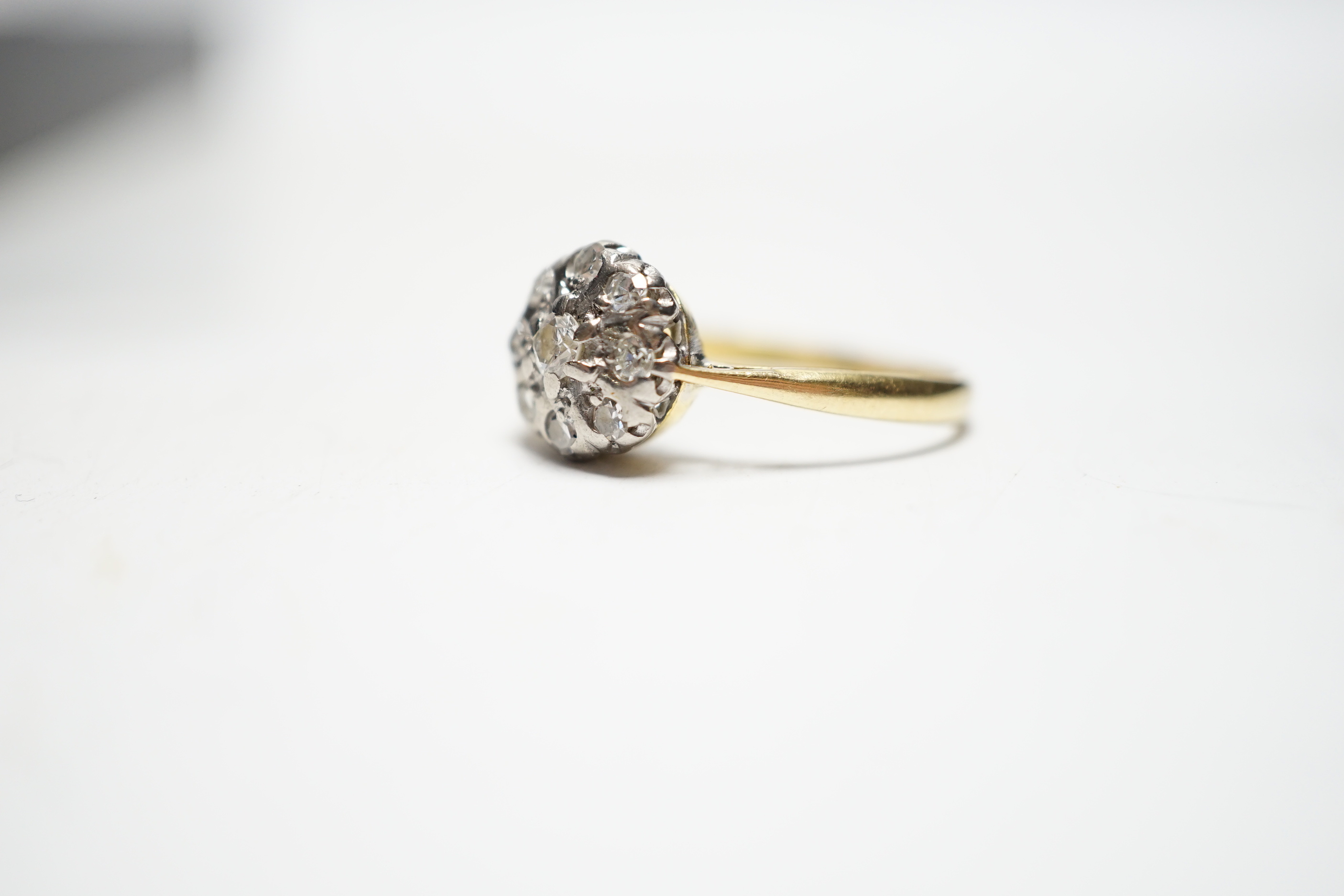 A 1960's 18ct gold and diamond cluster set flower head ring, size N/O gross weight 2.3 grams.